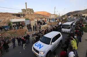 File - A convoy carrying wounded Syrian opposition fighters leaves the Lebanese border crossing point of Masnaa, Monday, Dec. 28, 2015.