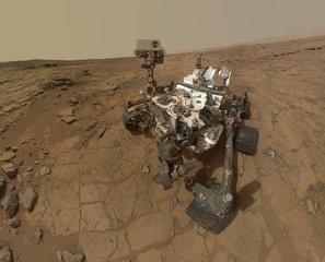 This self-portrait of NASA's Mars rover Curiosity combines dozens of exposures taken by the rover's Mars Hand Lens Imager on Feb. 3, 2013 plus three exposures taken May 10, 2013 to show two holes (in lower left quadrant) where Curiosity used its drill on the rock target "John Klein".