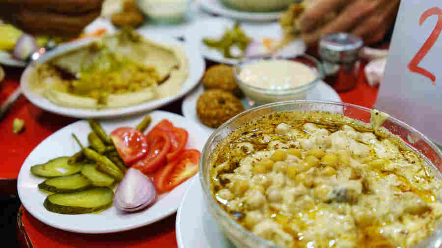 Plates piled with traditional Syrian food cover the table at Orijinal Halep Lokantasi, a restaurant in the southern Turkish city of Gaziantep.