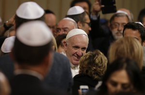 Pope Francis is greeted as he arrives at Rome's synagogue, Sunday, Jan. 17, 2016.