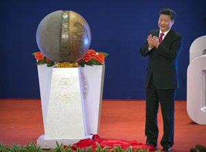 Chinese President Xi Jinping applauds after unveiling a sculpture during the opening ceremony of the Asian Infrastructure Investment Bank (AIIB) in Beijing, China, Saturday, Jan. 16, 2016.