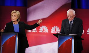 Democratic presidential candidate, Hillary Clinton gestures towards Democratic presidential candidate, Sen. Bernie Sanders, I-Vt, during the NBC, YouTube Democratic presidential debate at the Gaillard Center, Sunday, Jan. 17, 2016, in Charleston, S.C.