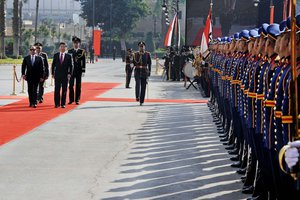 In this photo provided by the office of the Egyptian Presidency, Egyptian President Abdel-Fattah el-Sissi, left, welcomes Chinese President Xi Jinping at the Presidential Palace in Cairo, Egypt, Thursday, Jan. 21, 2016.