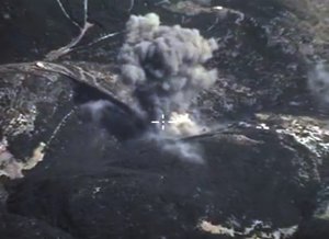 In this photo made from the footage taken from Russian Defense Ministry official web site on Sunday, Oct. 4, 2015, an aerial view of a bomb explosion in Syria.