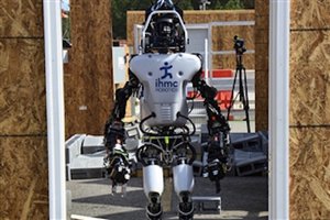 File - A robot awaits competition in the robotics challenge through the Defense Advanced Research Projects Agency, known as DARPA, in Pomona, Calif., June 5-6, 2015.