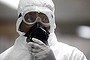 A health official wearing a protective suit waits to screen passengers in Lagos, Nigeria.