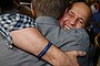 He's home: Peter Greste embraces a friend on returning to Australian soil.