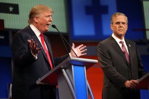 Republican presidential candidate Donald Trump speaks as Jeb Bush watches during the FOX News Channel Republican presidential debate at the Quicken Loans Arena Thursday, Aug. 6, 2015, in Cleveland.