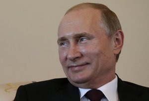 Russian President Vladimir Putin smiles