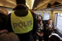 Swedish police check ID papers on a train travelling between Copenhagen in Denmark and Malmo in Sweden.