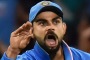 Stop talking ... Virat Kohli of India reacts after taking a catch to dismiss Steven Smith, who was commentating as he played.