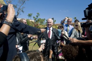 Robert M. Gates speaks to members of the press after observing Marine recruits at the Combat Conditioning Field.