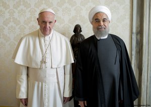 Pope Francis poses with Iranian President Hassan Rouhani at the Vatican, Tuesday, Jan. 26, 2016. Pope Francis held talks with the Iranian president Tuesday, and the Vatican said Tehran was called on to combat terrorism, now that the nuclear accord is bringing Iran a bigger role in regional conflicts. (AP Photo/L'Osservatore Romano/Pool Photo via AP)