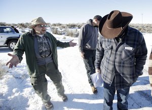 Burns resident Steve Atkins, left, talks with Ammon Bundy, right, one of the sons of Nevada rancher Cliven Bundy, following a news conference at Malheur National Wildlife Refuge Friday, Jan. 8, 2016, near Burns, Ore.