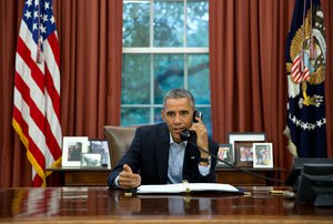 File - President Barack Obama talks on a conference call from the Oval Office with service members in Liberia and Senegal taking part in Operation United Assistance, the U.S. military campaign to contain the Ebola virus outbreak at its source, Nov. 1, 2014.