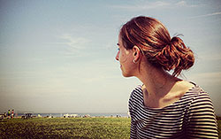 Girl looking out people on beach