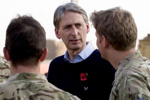 File - The British Secretary of State for Defence, Phillip Hammond talks to soldiers at Forward Operating base Shawqat in Helmand Province, Afghanistan during a visit, 20 March, 2013.