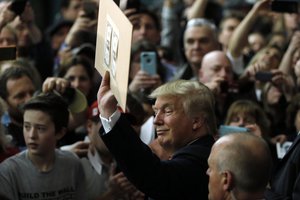 Republican presidential candidate Donald Trump meets with attendees during a campaign stop Tuesday, Feb. 2, 2016, in Milford, N.H.