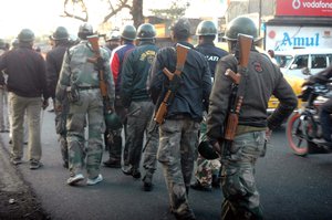 Police Commando Patroling  in front of Bamanghata TMC Party Office after the clash with CPI(M) on on January 8, 2013 in South 24 Parganas, India. A large number of vehicles were reportedly torched while more than dozen of cadres from both parties were injured in clash using firearms and stones. Reportedly convoy of Marxist leader Abdur Rezzak Mollah was attacked by TMC former MLA Arabul Islam leading to violent clash between cadres of two partie