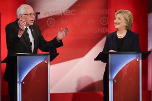 Democratic presidential candidate, former Secretary of State Hillary Clinton smiles as Democratic presidential candidate, Sen. Bernie Sanders, I-Vt,  answers a question during a Democratic presidential primary debate hosted by MSNBC at the University of New Hampshire Thursday, Feb. 4, 2016, in Durham, N.H.