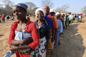 Women queue for food assistance distributed by the United Nations World Food Programme (WFP) in Mwenezi, about 450 kilometers (280 miles) south of Harare, Zimbabwe, Wednesday, Sept. 9 2015.