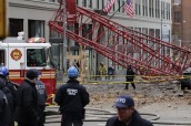 A collapsed crane lies on the street on Friday in New York.  