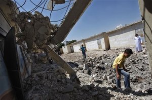 Syrians check the damage of a destroyed school after it was hit by an air strike killing six Syrians in town of Tal Rifat on the outskirts of Aleppo city, Syria, Wednesday, Aug. 8, 2012.