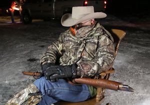 Arizona rancher LaVoy Finicum, holds a gun as he guards the Malheur National Wildlife Refuge, Tuesday, Jan. 5, 2016, near Burns, Ore.