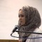 In this November 9, 2014 photograph, Mnar Muhawesh speaks about corporate media and the military-industrial complex at a meeting of the The Mideast Committee of WAMM (Women Against Military Madness) in Minneapolis, Minnesota. (YouTube)