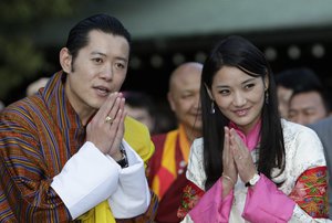 Bhutan's King Jigme Khesar Namgyal Wangchuck, left, and Queen Jetsun Pema greet for the media during their visit to Meiji Shrine in Tokyo Thursday, Nov. 17, 2011. The newly-wed royal couple was in Japan as state guests. (AP Photo/Shizuo Kambayashi)