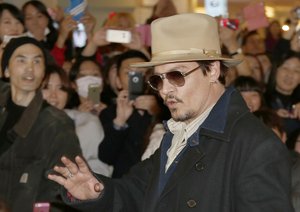 File - U.S. actor Johnny Depp waves to his fans upon arriving at Haneda international airport in Tokyo Monday, Jan. 26, 2015 for his latest film "Mortdecai" promotion.