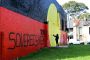 Aboriginal flag mural at Redfern's The Block reads 'sovereignty never ceded'. 