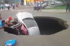 The dramatic rescue as a car disappears into a sinkhole in Peru.