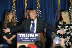 Republican presidential candidate, businessman Donald Trump speaks to supporters during a primary night rally, Tuesday, Feb. 9, 2016, in Manchester, N.H. At his side are his wife Melania Trump, left, and daughter Ivanka Trump, right. (AP Photo/David Goldman)