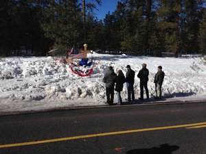 Mourners gather Sunday, Jan. 31, 2016, at roadside memorial for rancher LaVoy Finicum near Burns, Oregon. Finicum was killed Tuesday night in a confrontation with the FBI and Oregon State Police on a remote road.