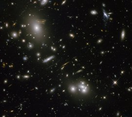 File - The gravitational field surrounding this massive cluster of galaxies, Abell 68, acts as a natural lens in space to brighten and magnify the light coming from very distant background galaxies.