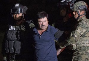 Mexican drug lord Joaquin "El Chapo" Guzman is escorted by army soldiers to a waiting helicopter, at a federal hangar in Mexico City, Friday, Jan. 8, 2016.