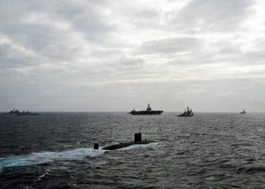 File - The Royal Navy Trafalgar-class nuclear submarine HMS Torbay (S90) is underway in formation with the George H.W. Bush Carrier Strike Group and other NATO ships during the U.K.-sponsored joint exercise Saxon Warrior 11, Atlantic Ocean, 20 May, 2011.