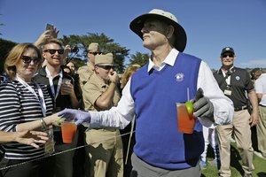 Bill Murray hands out Bloody Mary cocktails to fans on the 17th tee of the Pebble Beach Golf Links during the celebrity challenge event of the AT&T Pebble Beach National Pro-Am golf tournament Wednesday, Feb. 10, 2016, in Pebble Beach, California.