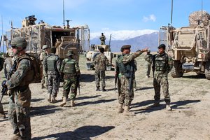 File - U.S. Marines and Georgian and Afghan soldiers prepare their equipment before conducting a patrol near Bagram Airfield, Afghanistan, April 6, 2015.