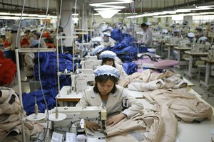 FILE - In this Dec. 19, 2013, file photo, North Korean workers assemble jackets at a factory of a South Korean-owned company at the jointly-run Kaesong Industrial Complex, in Kaesong, North Korea.