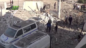 This image taken from video provided by the Syrian activist-based media group Azaz Media Center, which has-been verified and is consistent with other AP reporting, shows people gathered around destroyed vehicles in Azaz, Syria Syria, Monday, Feb. 15, 2016.