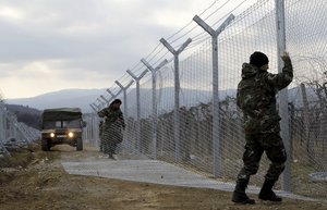 In this February 8, 2016 file photo, Macedonian Army soldiers erect a second fence on the border line with Greece, near the southern Macedonia's town of Gevgelija.