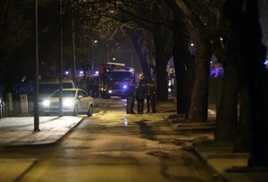 Security officials and forensic experts at the explosion site in Ankara, Turkey, Wednesday, Feb. 17, 2016, after assailants exploded a car bomb near vehicles carrying military personnel in the Turkish capital, killing several people and injuring scores of others, officials said. The explosion occurred during evening rush hour in the heart of city, in an area close to where military headquarters and the parliament are located.