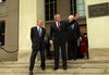 File - President George W. Bush waves to photographers as he comes down the steps at the Pentagon with Secretary of Defense Donald H. Rumsfeld (left) and Vice President Dick Cheney (obscured) on Jan. 4, 2006.