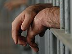 Man behind bars. Jail. Prison. Prisoner. Hands. Generic image.