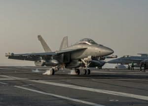 An EA-18G Growler from the Cougars of Electronic Attack Squadron (VAQ) 139 makes an arrested landing on the flight deck of the Nimitz-class aircraft carrier USS Carl Vinson (CVN 70)