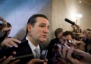 Sen. Ted Cruz, R-Texas, speaks to reporters waiting outside a closed-door meeting of Senate Republicans as news emerged that leaders reached a last-minute agreement to avert a threatened Treasury default and reopen the government after a partial, 16-day shutdown, at the Capitol in Washington, Wednesday, Oct. 16, 2013. Cruz said he would not try to block the agreement.