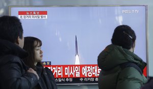 South Koreans watch a TV news program with a file footage about North Korea's rocket launch at Seoul Railway Station in Seoul, South Korea, Sunday, Feb. 7, 2016.