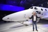 Sir Richard Branson poses in front of Virgin Galactic's SpaceShipTwo space tourism rocket after it was unveiled, Friday, ...